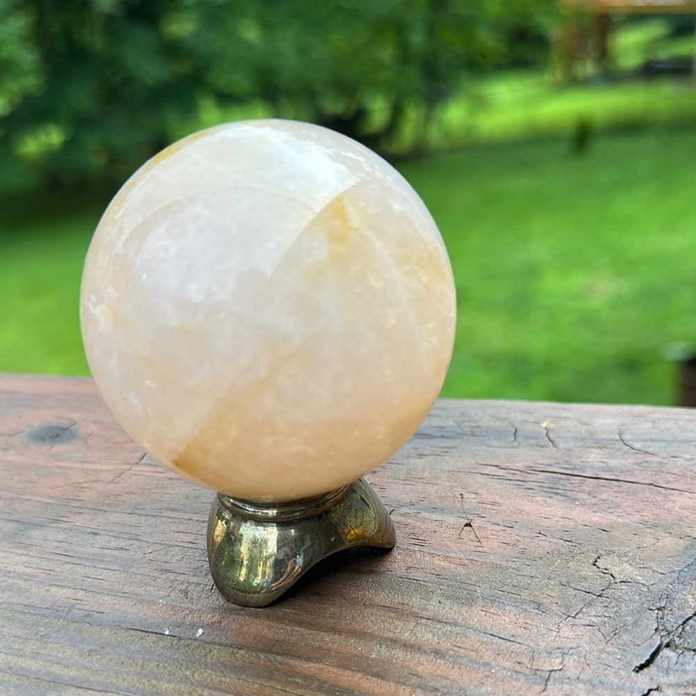 Cream smooth Crystal Sphere with Silver Plated Stand about 3”